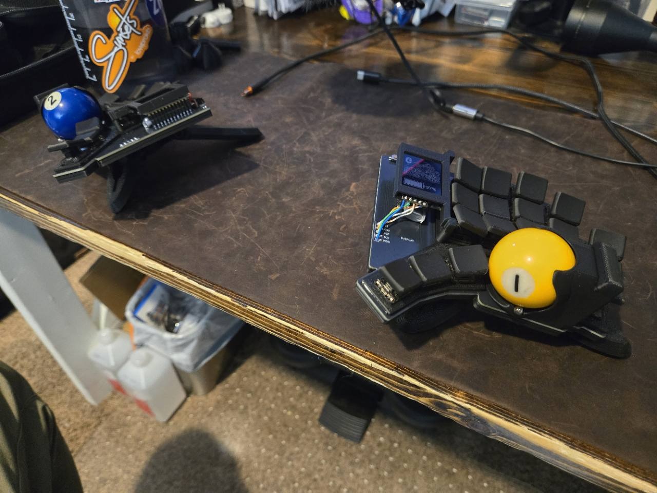 Tempest Dux prototypes with blue and yellow trackballs on my desk.